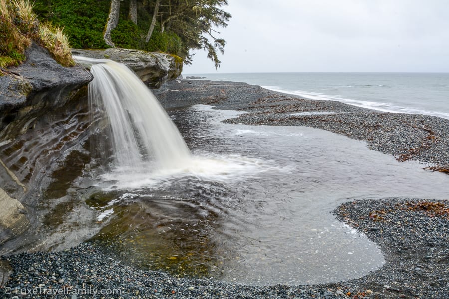 A waterfall with a pool underneath on Sandcut Beach