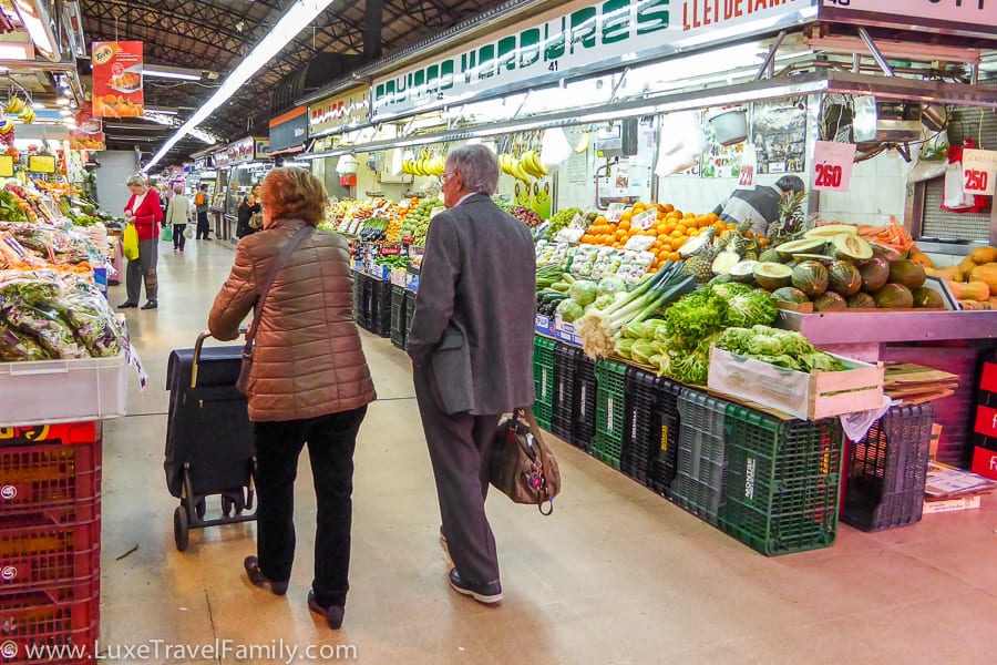 An elderly couple shopping in Mercat de l'Abaceria in Barcelona